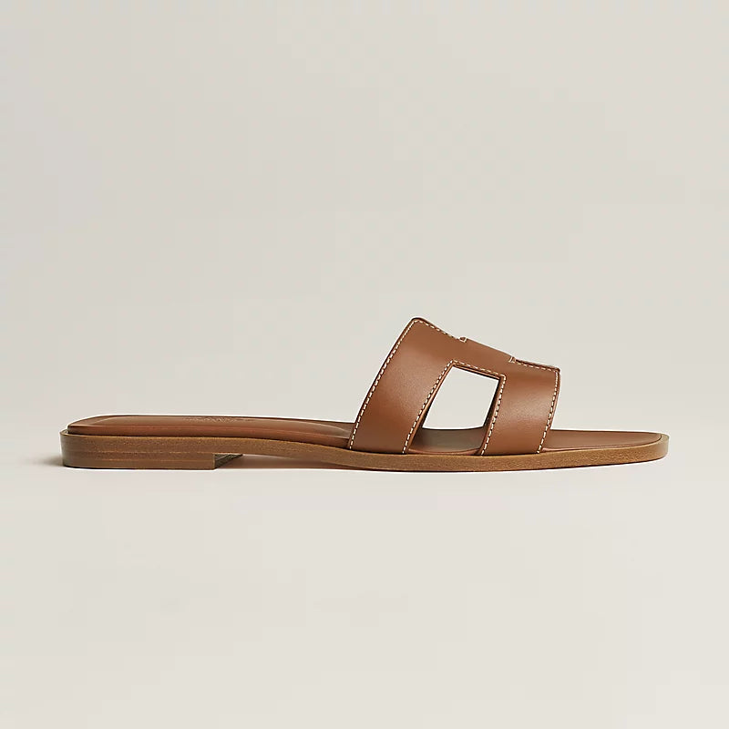 Oran sandal tan leather with wide toe loop, open heel, flat sole