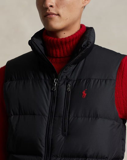 Black down gilet close-up: double zip pulls, high collar, embroidered Polo logo
