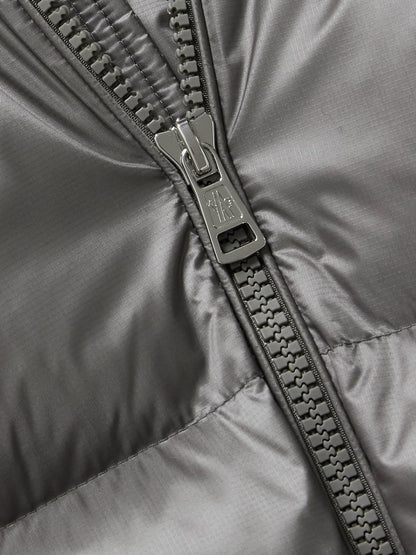 Gray jacket close-up: metal zipper and stitched seam details