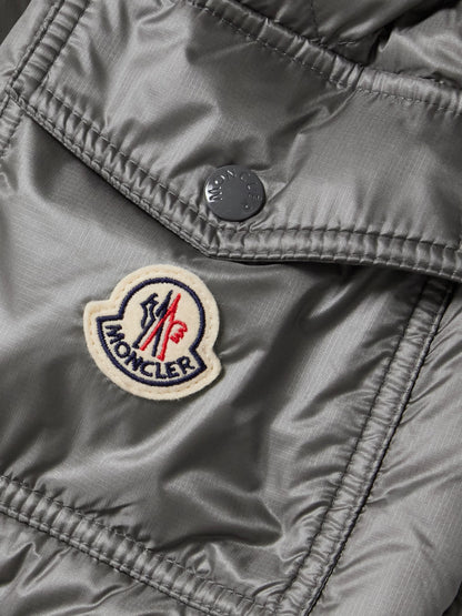 Gray down jacket fabric close-up with MONCLER patch
