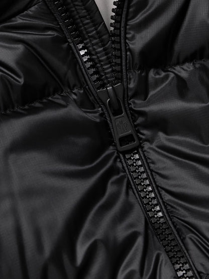 Black jacket close-up: black zipper pull and zipper track detail