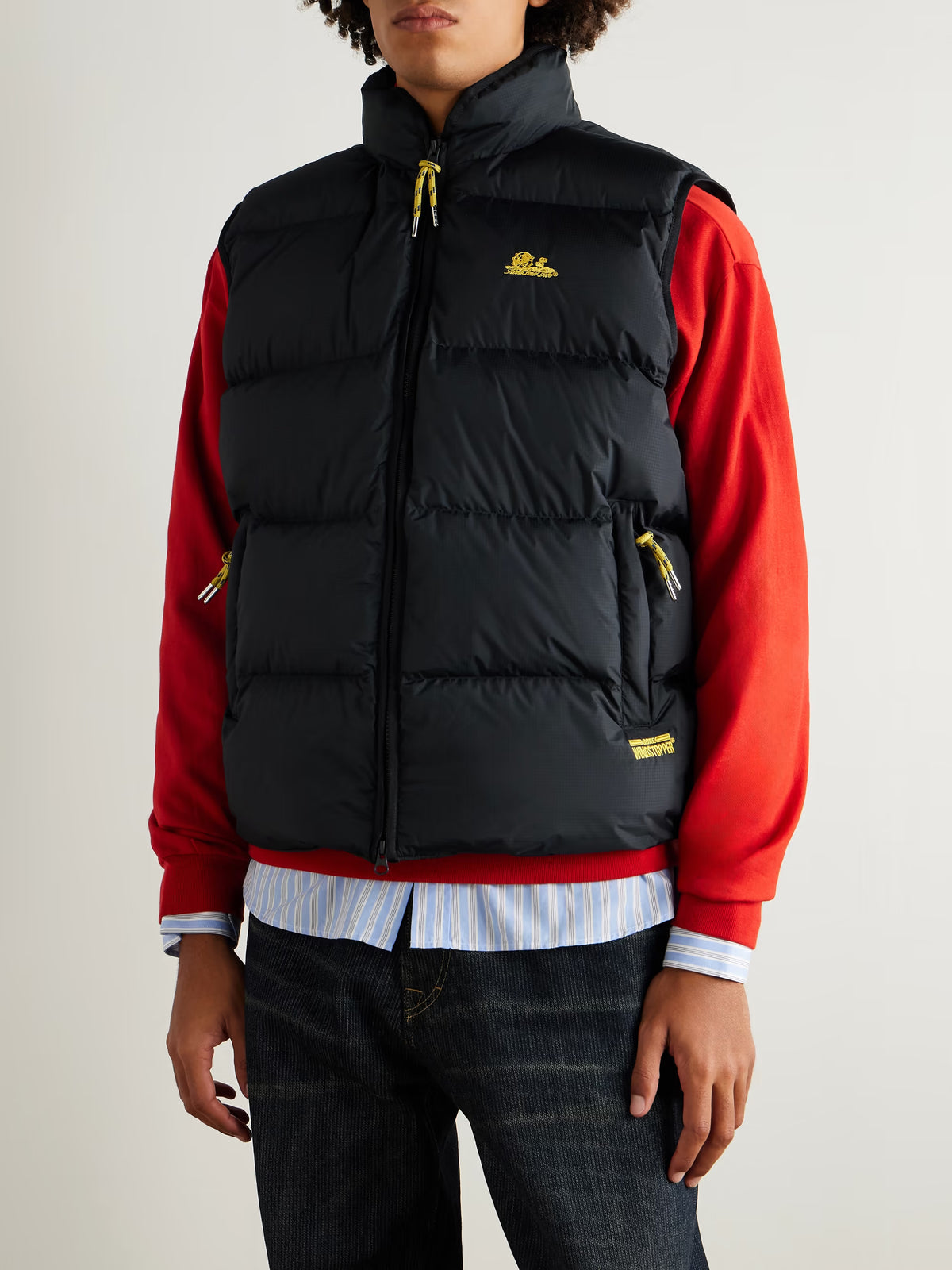 Black quilted logo vest with embroidered chest logo and gold zipper cord pulls