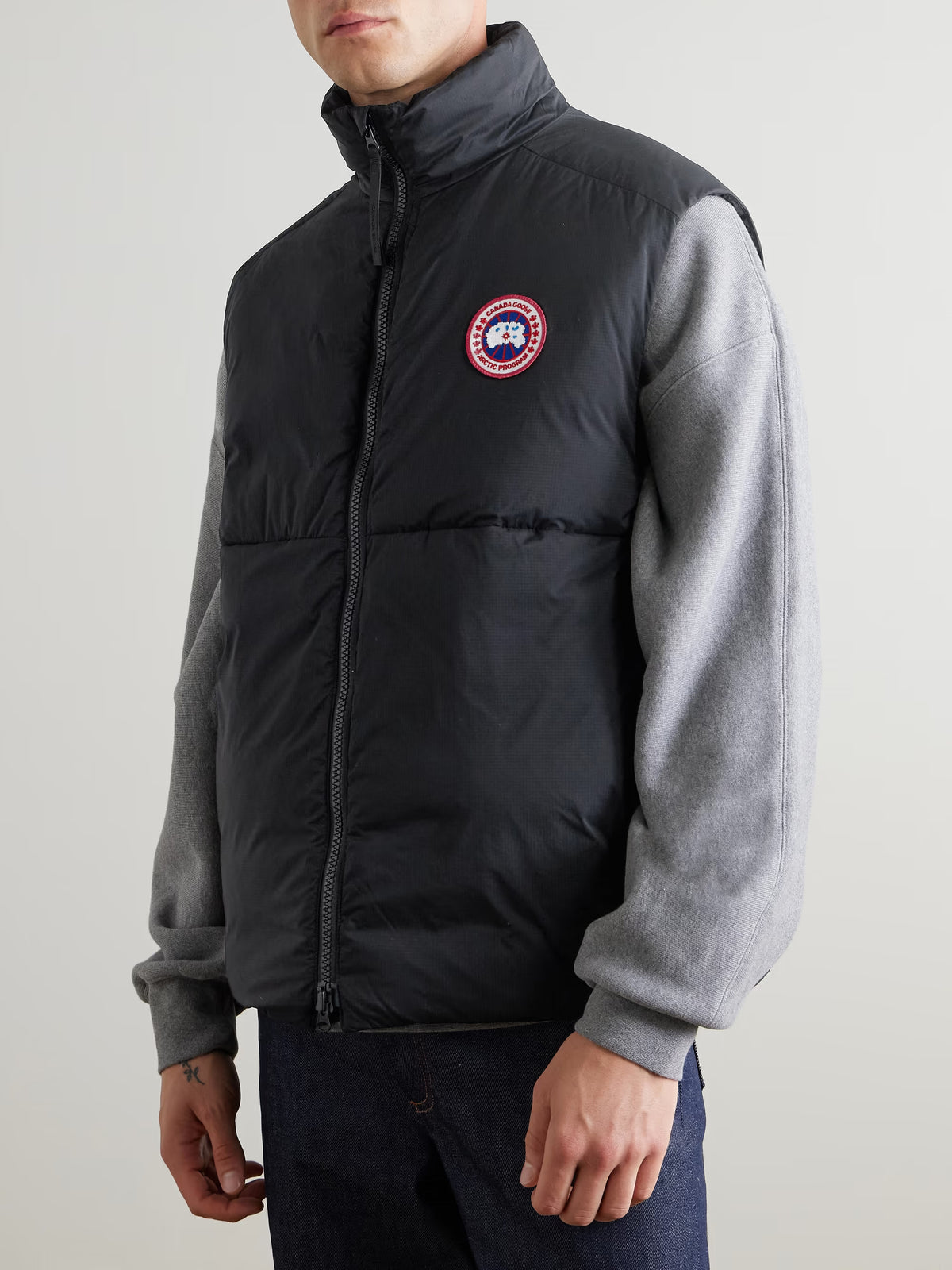 Black Lodge down gilet with stand collar and chest logo patch, side view