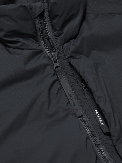 Black ripstop down gilet close-up: full-zip with branded pull tab and pocket opening